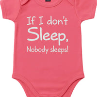 Pink babysuit with white text on a white background